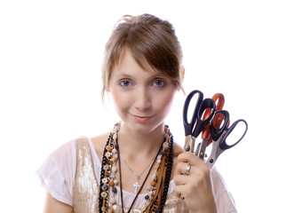 young girl holds in her hand scissors