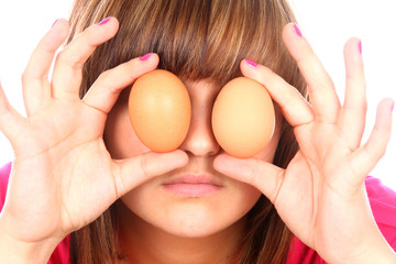 Teenage Girl Playing with Eggs. Model Released - obrazy, fototapety, plakaty