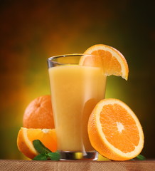 Oranges and glass of juice.