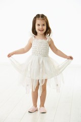 Naklejka premium Laughing little girl in ballet costume