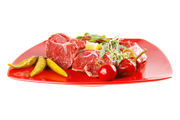 uncooked meat medallion on red