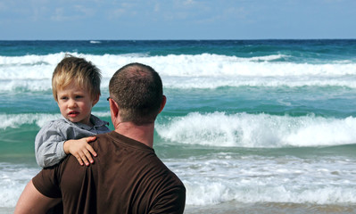 Fototapeta na wymiar father and son playing on a beach