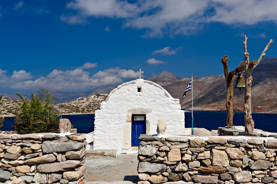 Orthodox white church with wooden church-bell in Greece