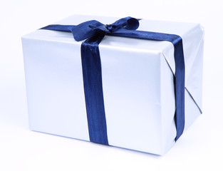 Gift in silver wrapping with a blue bow on white background