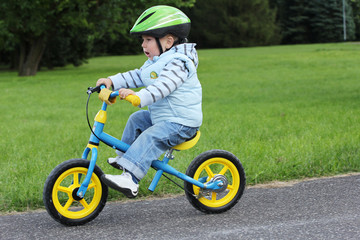 Child learning to ride on his first bike