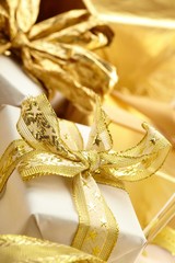 Fototapeta na wymiar gift boxes with gold ribbon