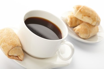 Cup of coffee with a roll