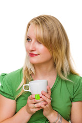 Young woman with a cup of tea, day dreaming