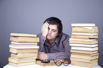 The young tired student with the books isolated.