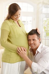 Dad listening to baby in belly