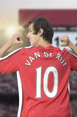 Soccer player is pointing at his back