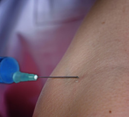 Portrait of a young doctor with syringa.