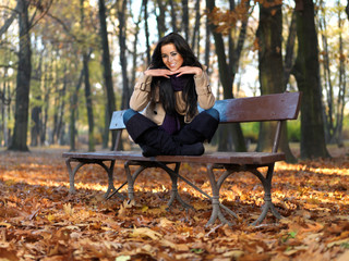 Beautiful woman spending time in park during autumn season