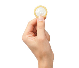 Condom in hand isolated on white