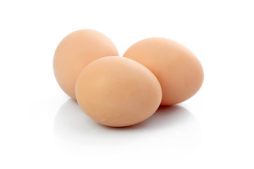 Three brown raw eggs isolated