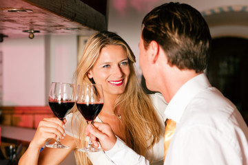 Man and woman flirting in hotel bar