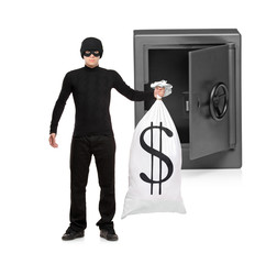 Full length portrait of a thief stealing a money bag from a safe