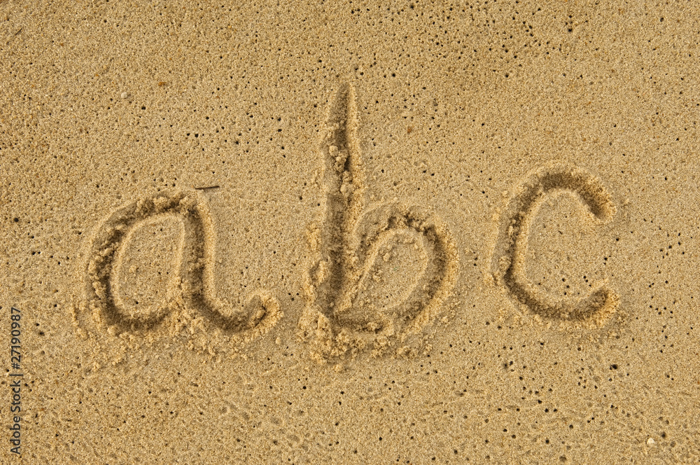 Wall mural alphabet letters a b c handwritten in sand on beach