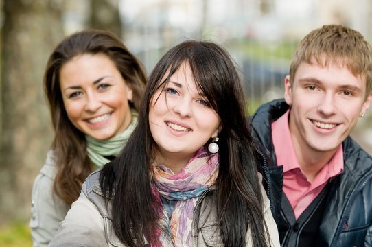 Group of smiling young students outdoors