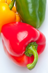 Macro shot of colorful bell peppers isolated on white