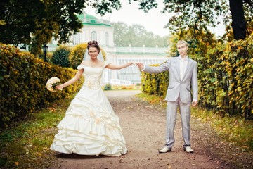 Portrait of newlyweds walking in moscow estate