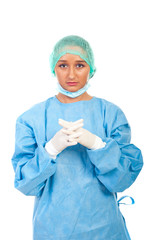 Serious surgeon woman with sterile gloves