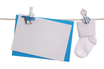 Baby sock and blank note hanging on the clothesline