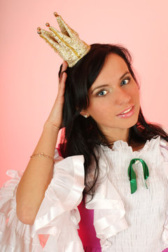 beautiful princess with crown over pink background