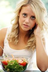 Obraz na płótnie Canvas Teenage Girl Eating Prawn Salad. Model Released