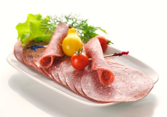 Sliced Salami with tomatoes and salad leaves