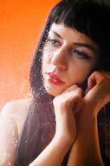 Naklejka premium Woman behind glass