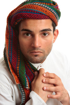 Mixed race middle eastern man wearing turban robe