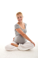 Beautiful pregnant woman doing exercises