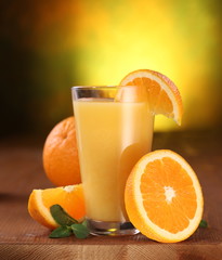 Oranges and glass of juice.