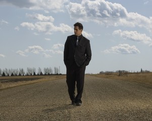 Businessman Walking On Road