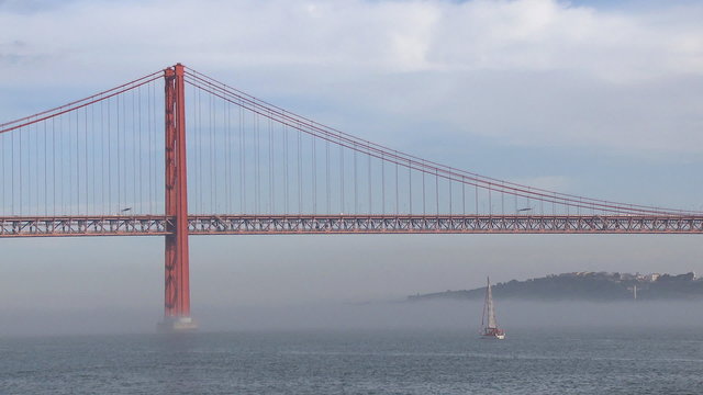 Bridge on fog river and sailboat Lisbon
