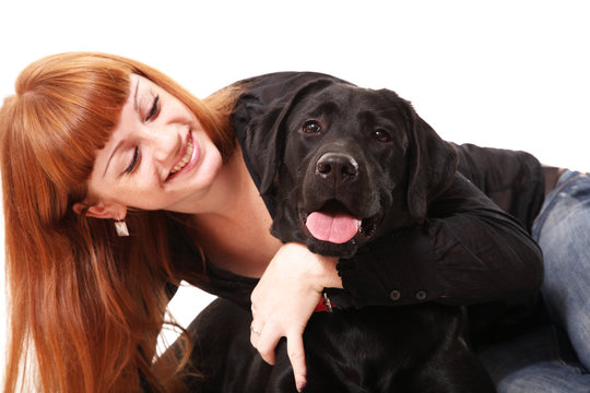 The young woman hugging a mix breed dog