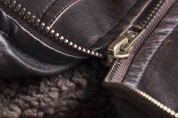 Zipper of a brown leather jacket