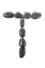 Letter 'T' made of stones isolated on white