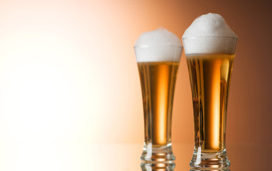 Beer glasses against the colorful gradient background