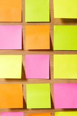 Many reminder notes on the wooden background