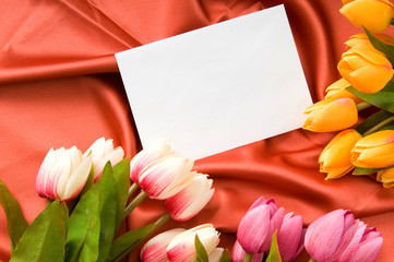 Envelope and flowers on the satin background