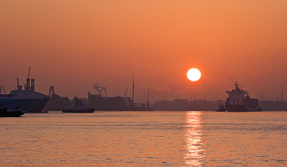 Red sunrise on the foggy river