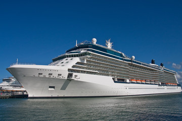 Fototapeta na wymiar Luxury Cruise Ship Docked Under Blue Sky