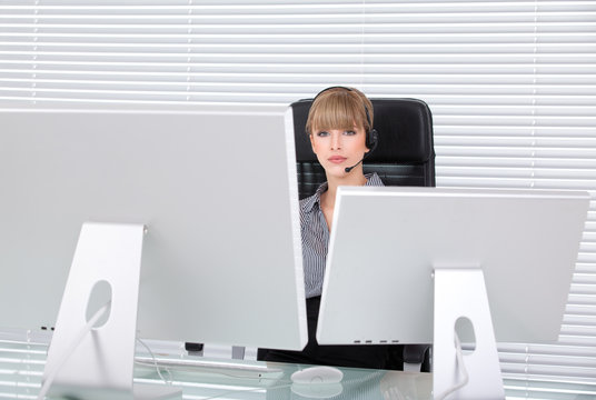 Young Business Woman In Her Office With Head Phones