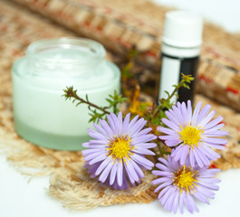 bottles of essential oil and flower