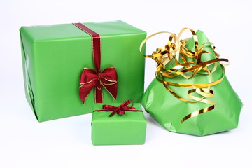 Gifts in green wrapping with bows on white background