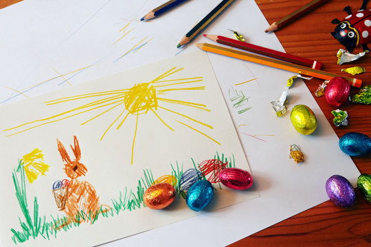 drawing of the Easter bunny, chocolate eggs and colored pencils