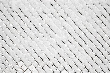 Chain link fence covered under fresh snow