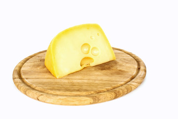 piece of cheese on a wooden board